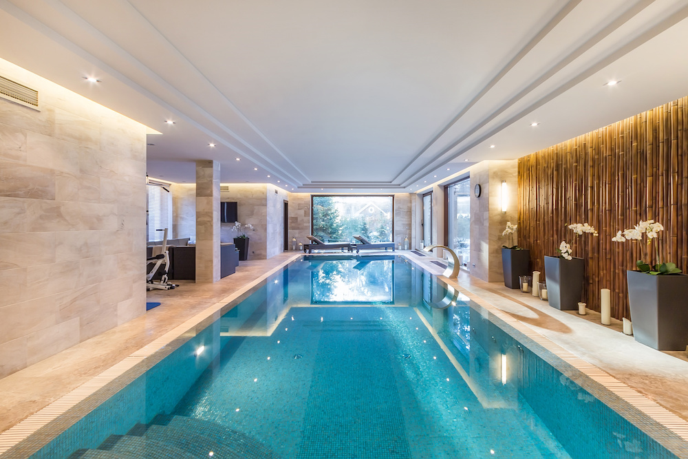 Magnificent indoor private pool with waterfall jet. Exercise equipment and sun beds.