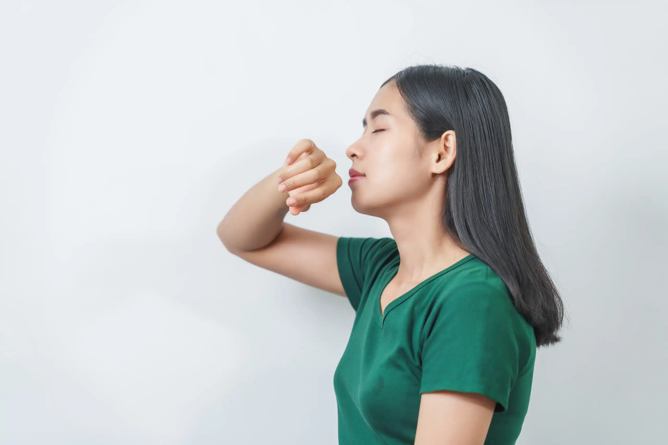Winter Indoor Living: Ambient Scenting for Comfort & Mood A woman sniffing her hand and the air, enjoying ambient scenting