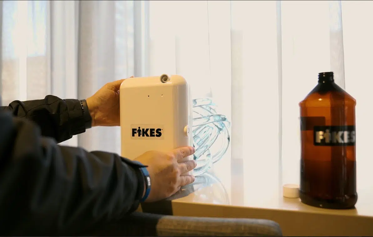 Winter Indoor Living: Ambient Scenting for Comfort & Mood A person installing Fikes scenting solutions in a building