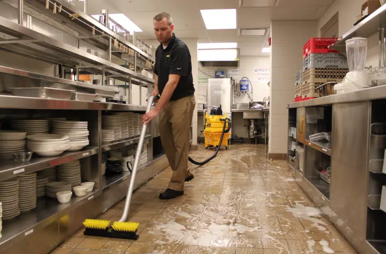 The "Zero-Tolerance" Strategy for Restaurant Pest Control Man cleaning a commercial kitchen
