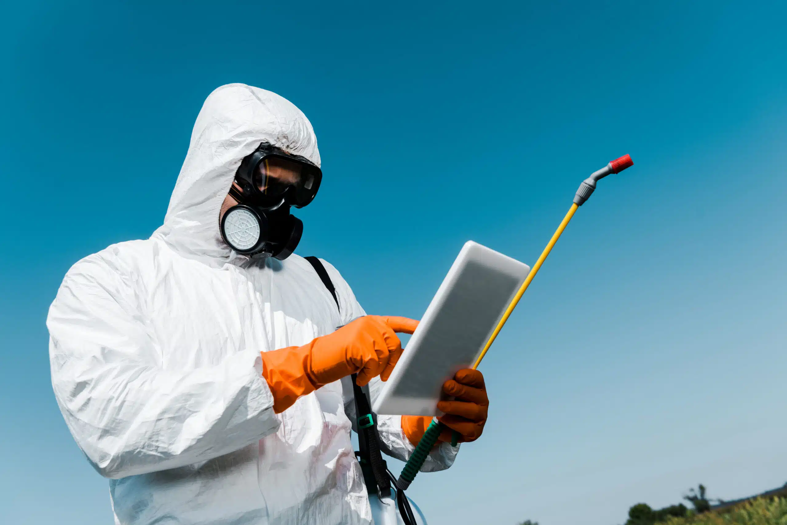 The Modern Pest Control Toolbox: Technology, Monitoring & Data-Driven Prevention Pest control worker holding a tablet going over data | modern pest control