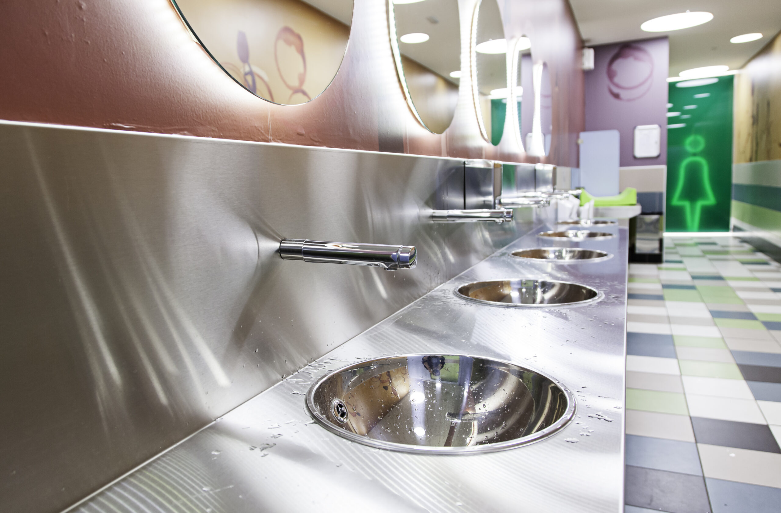 Why Specialized Restroom Sanitation Is Non-Negotiable for High-Volume Venues & Entertainment Facilities close up shot of public restroom sinks