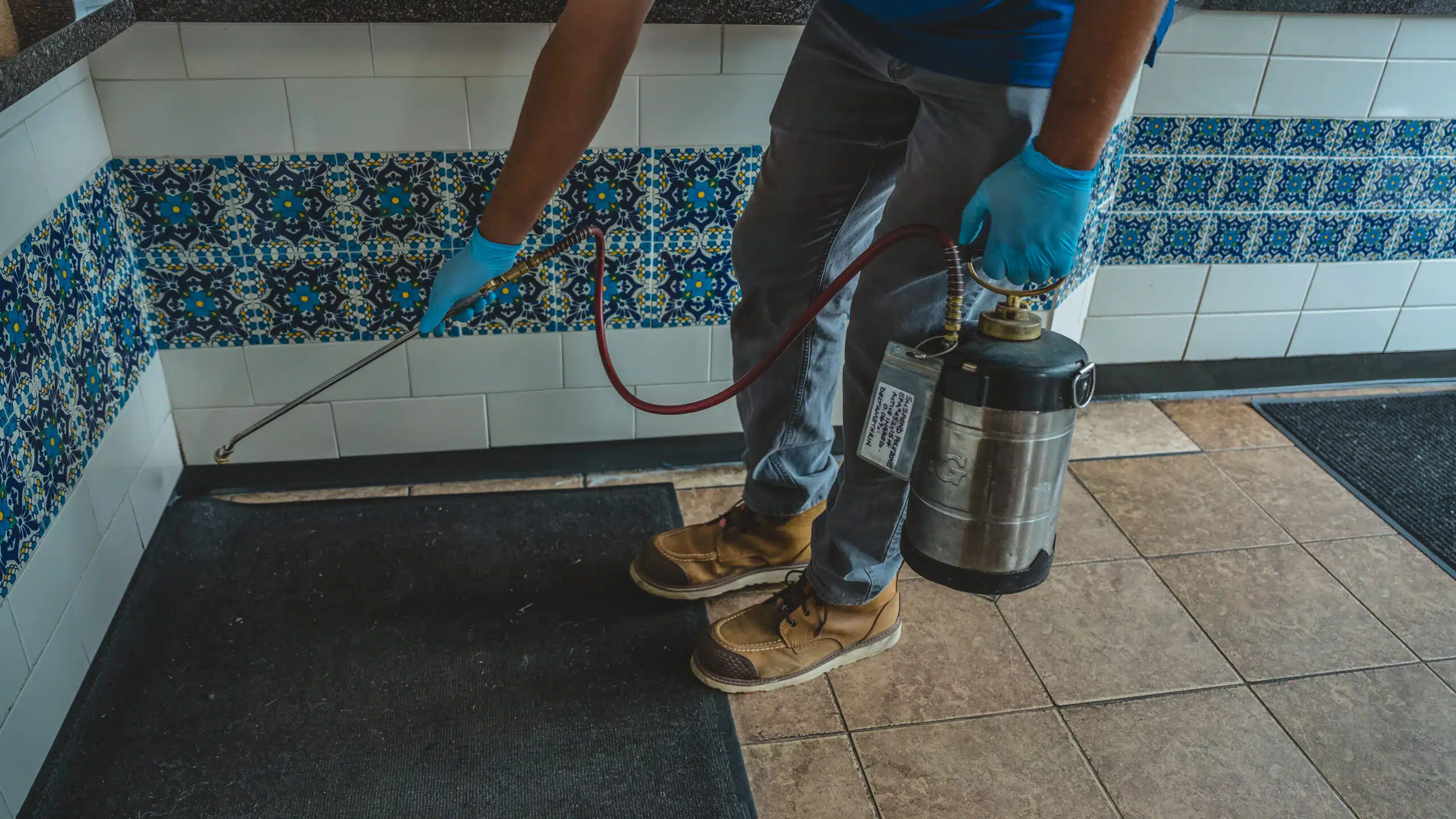 How High Summer Temperatures Fuel Commercial Kitchen Fruit Flies man spraying pest control chemicals in a restaurant