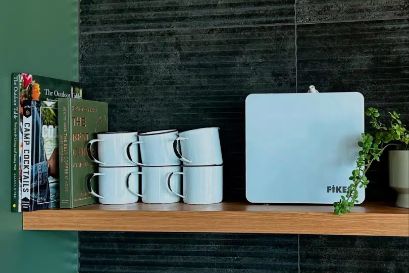 Autumn Scent Branding: How to Use Fall Fragrances to Increase Retail Foot Traffic Scenting machine sitting on table on a wall with mugs and books next to it